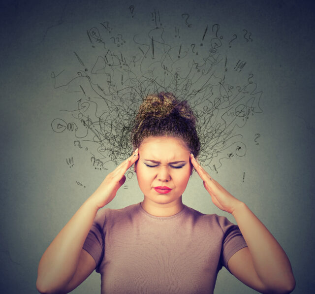 woman with worried stressed face expression and brain melting in